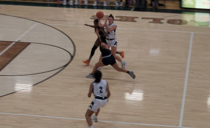 Elyria Catholic's Isabelle Niederst passes off to a teammate during Frdiay's win over Bishop hartley. Photo credit: Ryan Isley, SBLive Sports